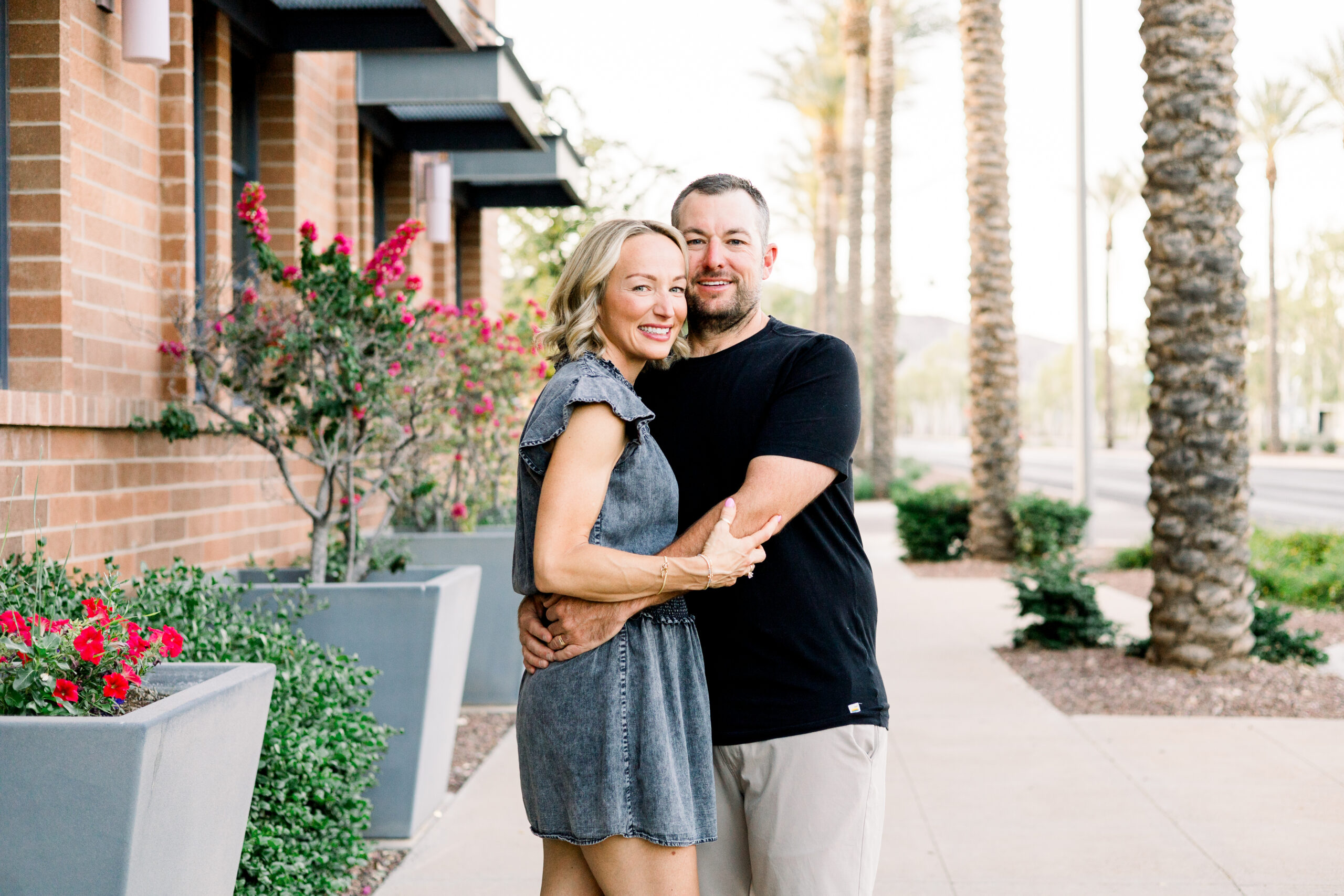 Couple poses in Verrado, Arizona for a family photography session.