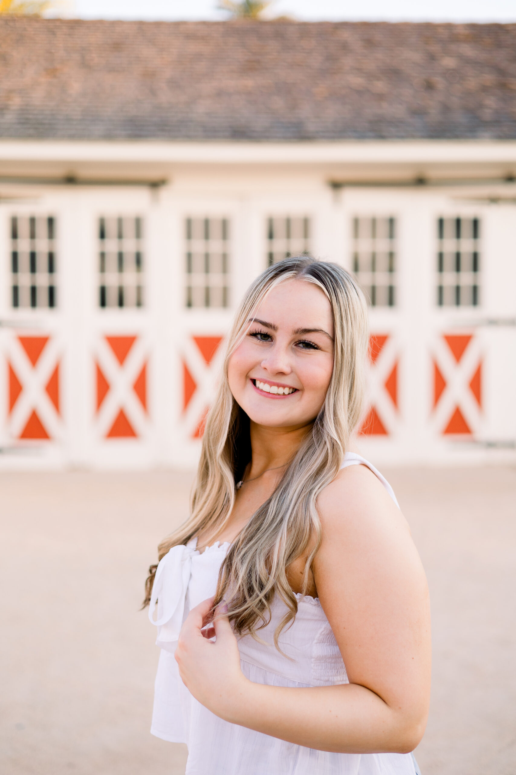 Senior stands in front of historic stable at Sahuaro Ranch Park.